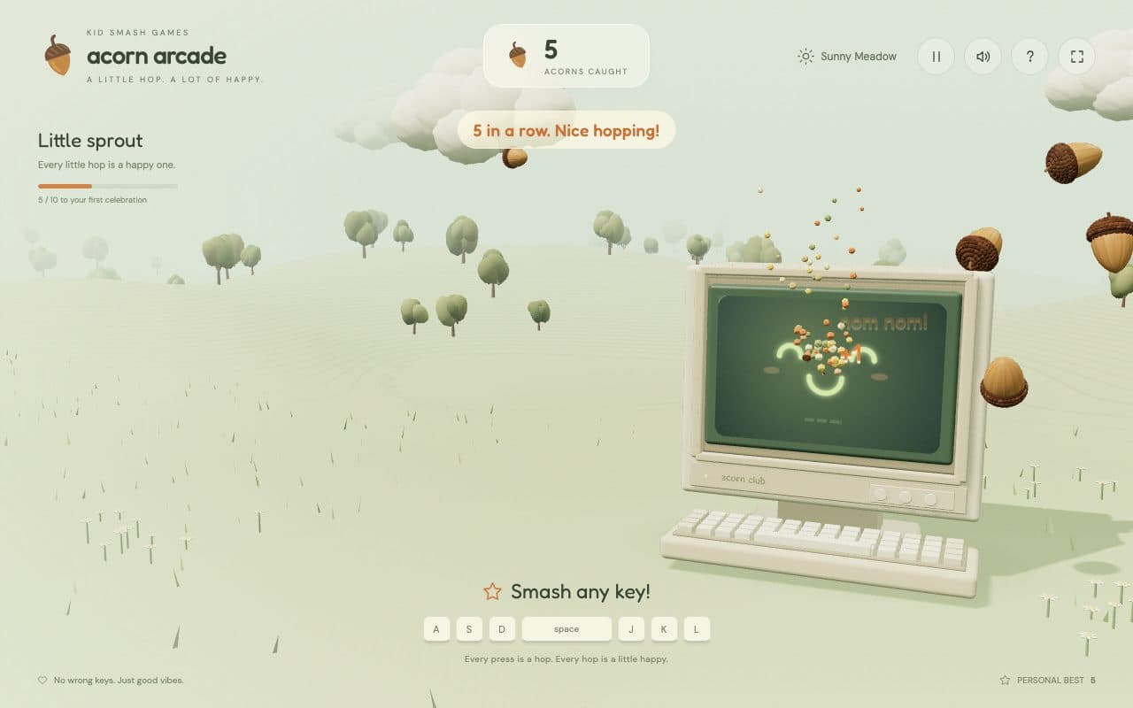 A beige retro computer hopping through a sunny 3D meadow to catch falling acorns, with a score card and a row of keyboard keys